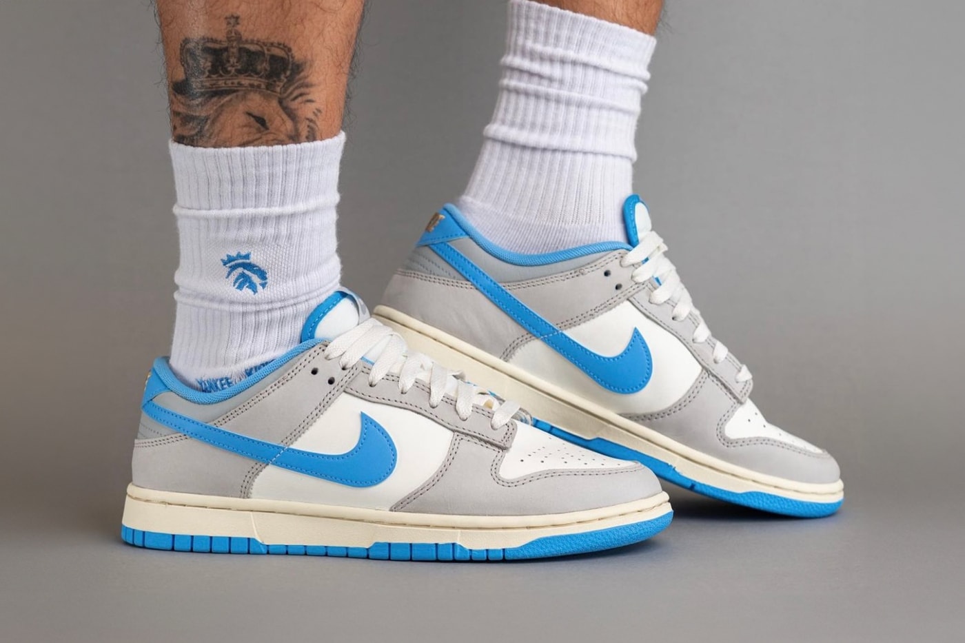On-Feet Look at the Nike Dunk Low "Athletic Department" FN7488-133 Sail/University Blue-Light Iron Ore-Light Smoke Grey-Coconut Milk sneakers swoosh low top university blue