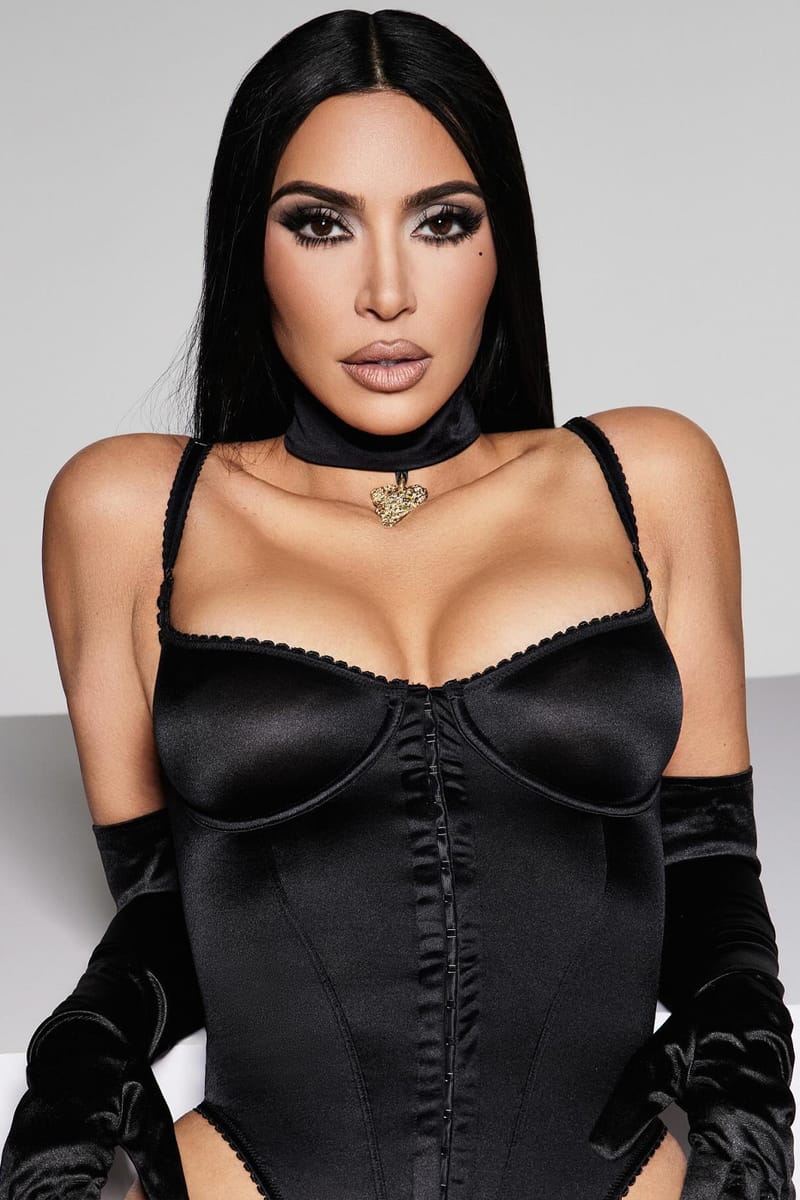 Kim Kardashian Poses in Late Night Intimates for New Stretch Satin SKIMS Campaign Veneda Carter gold bold heart pendant lustruous kim k shape wear onyx