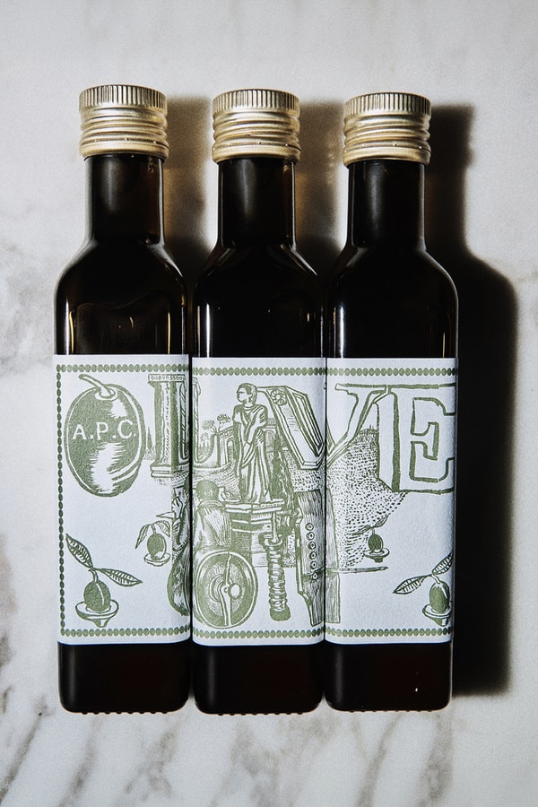A.P.C. Drops Cooking Essentials in Olive Oil and Apron Combo france season 3 kitchen mathias m/m graphic studio