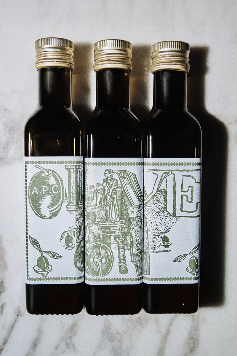 A.P.C. Drops Cooking Essentials in Olive Oil and Apron Combo france season 3 kitchen mathias m/m graphic studio