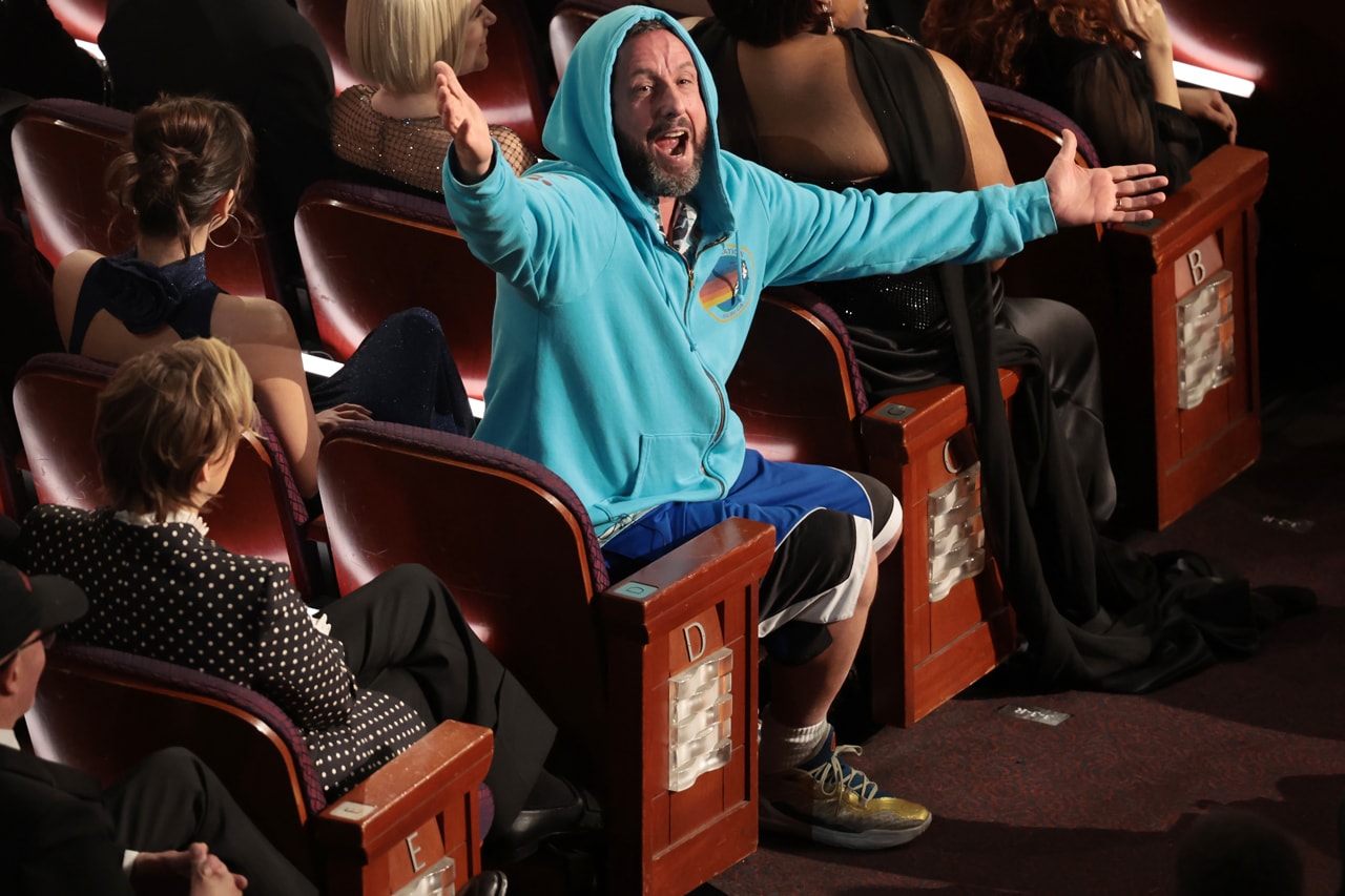 Adam Sandler Doesn’t Give a F*ck – and Neither Should You oscars academy awards show conan o'brien host hoodie anora sweatpants shorts curry 11 under armour basketball sneakers 