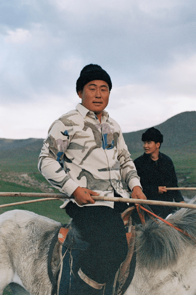 Mongolian steppe A Kind Of Guise's FW25 collection, Altai Mirage, Artist Jonathan Niclaus, Italian cotton corduroy, lambswool and hairy wool blends, purple dragon emblem,Dragon Wool Jacket and the Khivs Pullover.