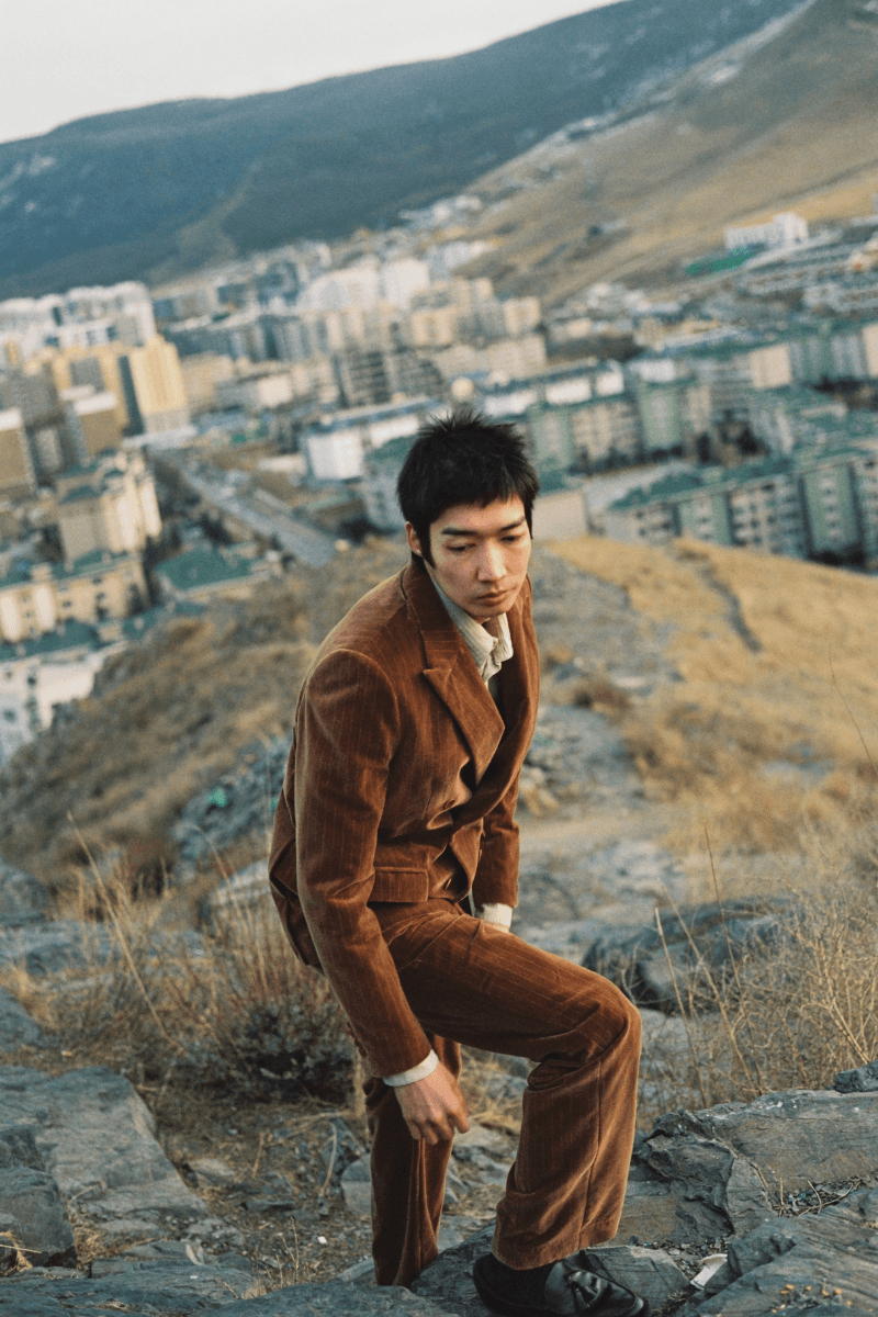 Mongolian steppe A Kind Of Guise's FW25 collection, Altai Mirage, Artist Jonathan Niclaus, Italian cotton corduroy, lambswool and hairy wool blends, purple dragon emblem,Dragon Wool Jacket and the Khivs Pullover.