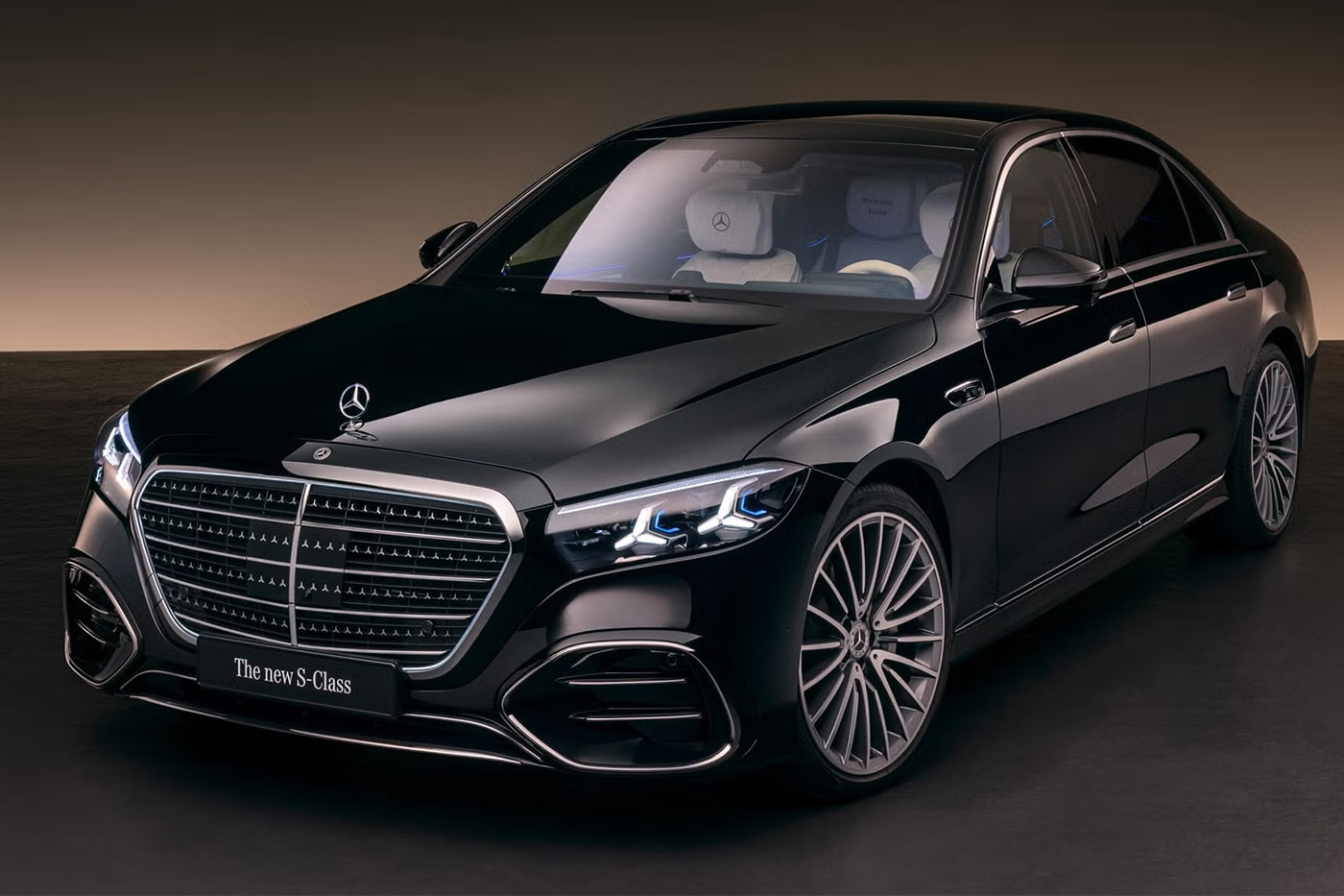 2027 Mercedes-Benz S-Class showcasing illuminated grille and triple-screen MBUX Superscreen interior with MB.OS supercomputer