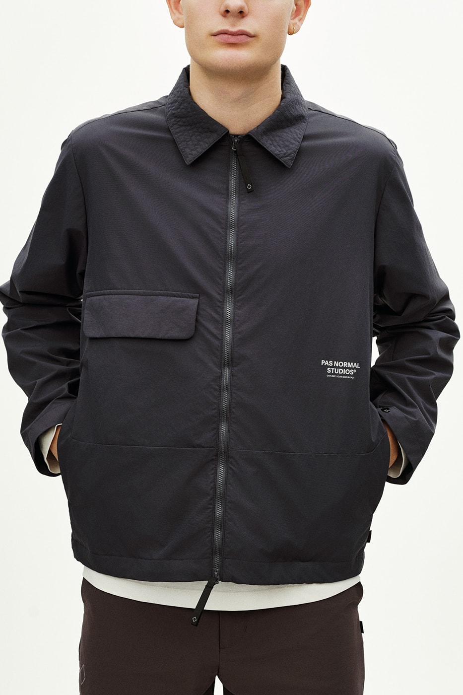 Pas Normal Studios SS26 Off-Race blends cycling utility with everyday style, featuring Polartec® fleece and waterproof commuters.