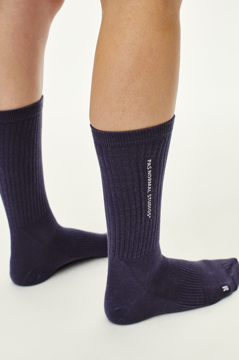 Pas Normal Studios SS26 Off-Race blends cycling utility with everyday style, featuring Polartec® fleece and waterproof commuters.