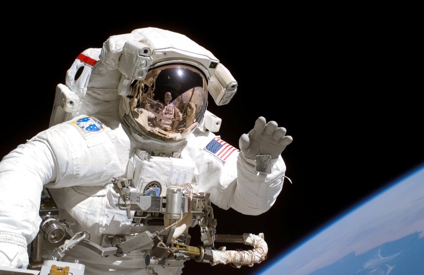 NASA astronaut using a modern smartphone during the Crew-12 or Artemis II mission to capture images in space