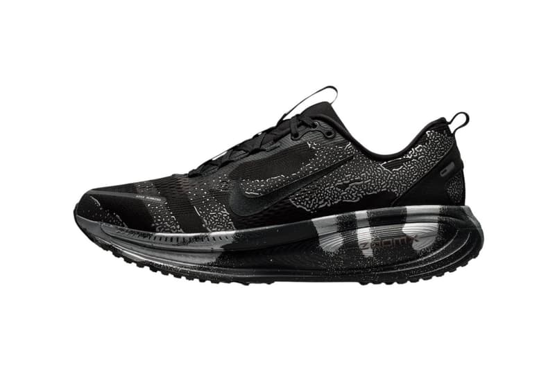 Nike Vomero 18 DSRPT in Iron Grey, Light Smoke Grey, and Black colorway showing abstract two-tone design on running shoe upper - detail view 2