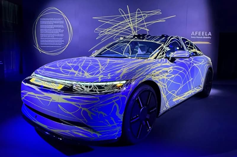 Sony Honda Afeela 1 art cars by Hajime Sorayama and Matt Copson with chrome and reflective wraps on display