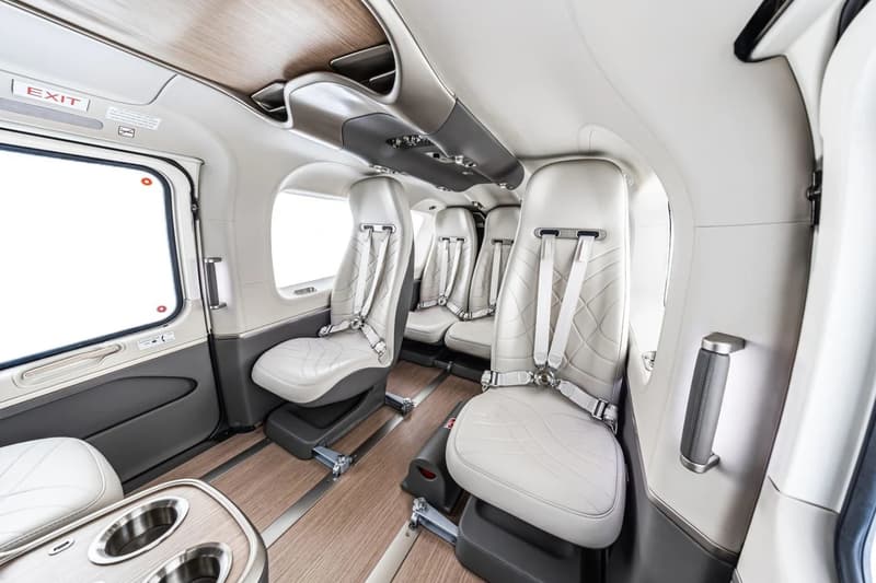 ACH145 Mercedes-Benz Edition helicopter interior featuring EQS and Maybach-inspired leather lounge cabin with wood flooring