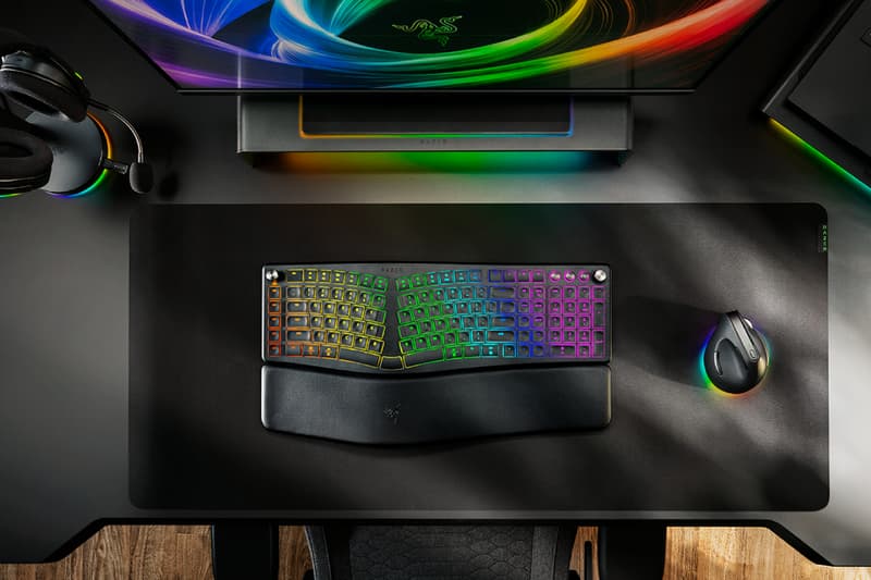 Razer Pro Type Ergo wireless ergonomic keyboard with split Alice-style layout, wrist rest and RGB lighting on a modern desk setup.