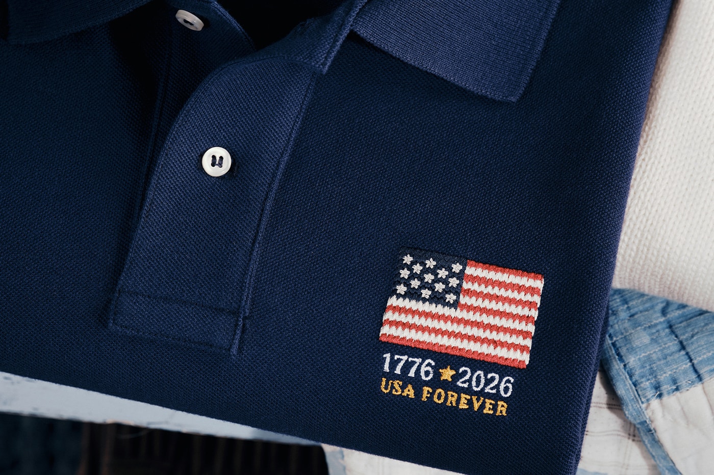 Special Delivery: Ralph Lauren Curates Historic USPS Stamp Collection for America's 250th Anniversary exclusive apparel capsule American Flag Sweater, a classic Polo Shirt, and a tailored Ball Cap united states accessories