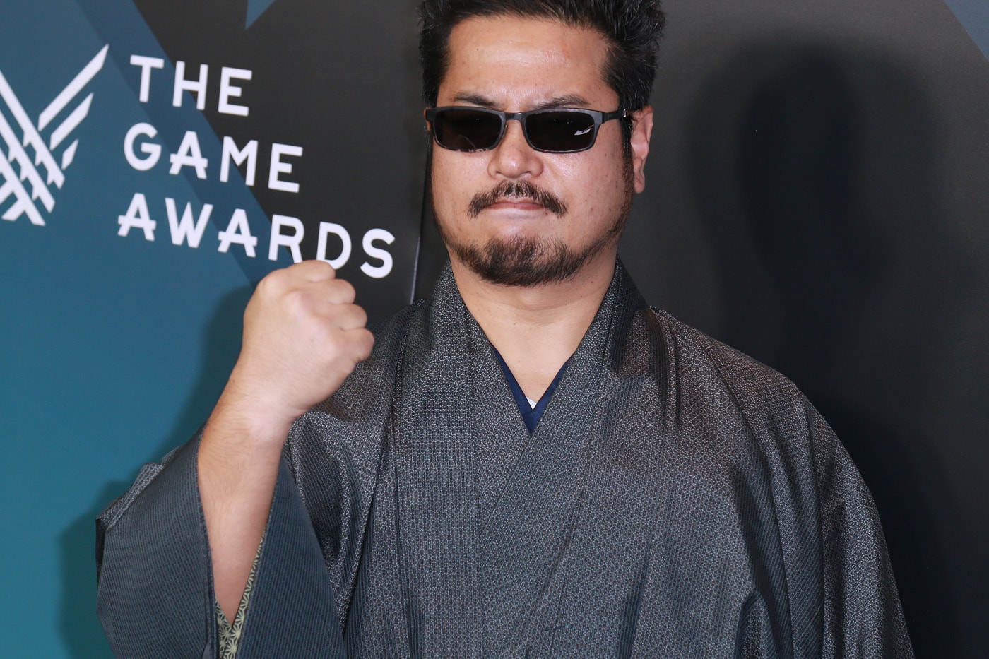 Katsuhiro Harada with VS Studio SNK branding and Visionary Standard tagline