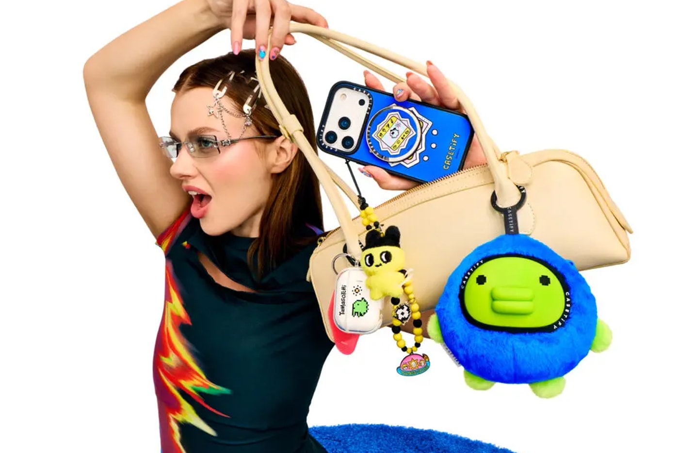 CASETiFY and Tamagotchi Team up for a Retro SS26 Accessories Collection collaboration carry on suitcase phone accessories 