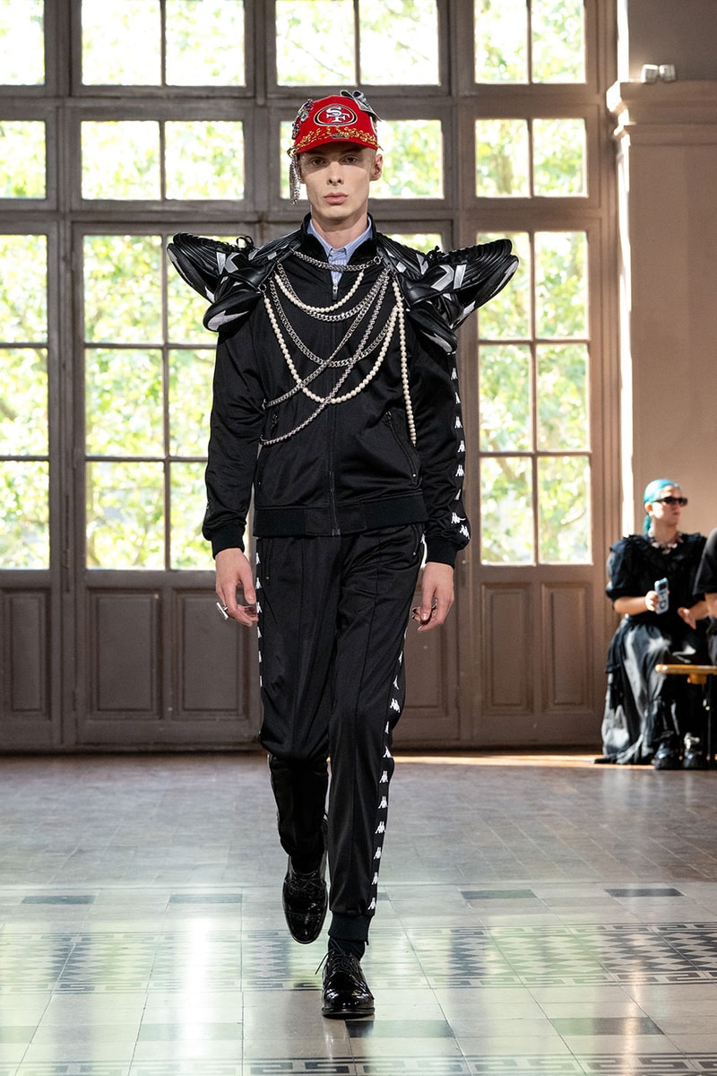 JUNYA WATANABE MAN SS27 Blends Streetwear Icons and Luxury Tailoring Under "BLING BLING BLING" Theme paris fashion week spring summer 2027 runway Kappa  Needles  Carhartt  Levi’s  Luigi Borrelli  Guy Rover  Maria Santangelo  INNERRAUM  47  HIDDEN   Union LA  DHL  Flake  New Balance  Heinrich Dinkelacker  Tricker's 