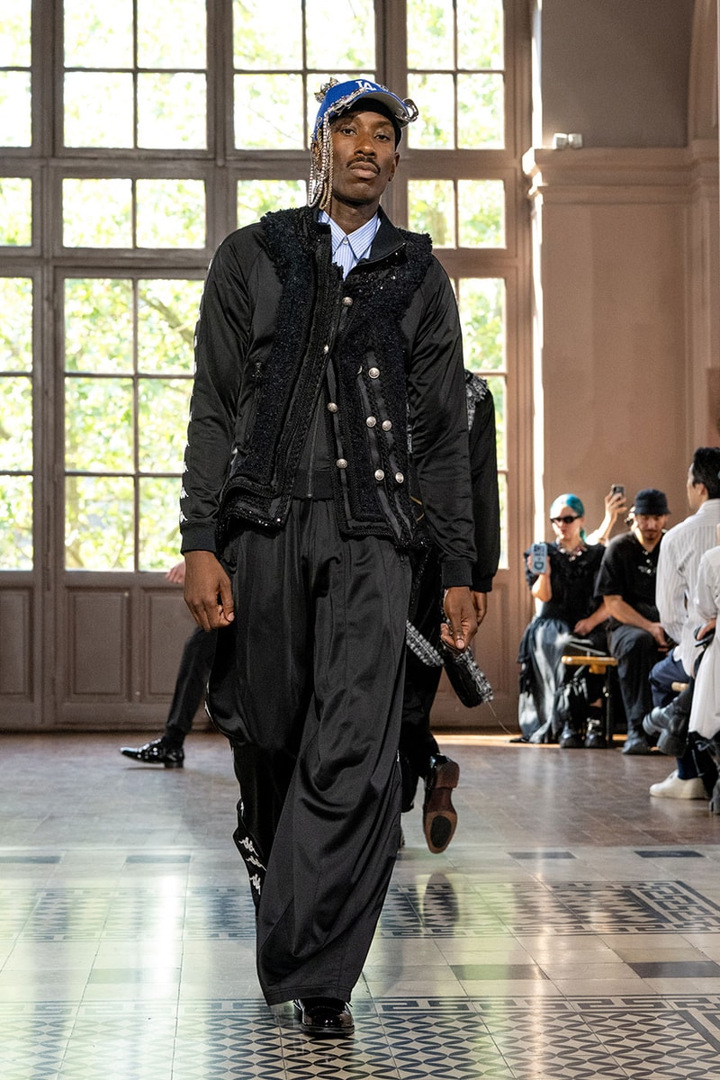 JUNYA WATANABE MAN SS27 Blends Streetwear Icons and Luxury Tailoring Under "BLING BLING BLING" Theme paris fashion week spring summer 2027 runway Kappa  Needles  Carhartt  Levi’s  Luigi Borrelli  Guy Rover  Maria Santangelo  INNERRAUM  47  HIDDEN   Union LA  DHL  Flake  New Balance  Heinrich Dinkelacker  Tricker's 