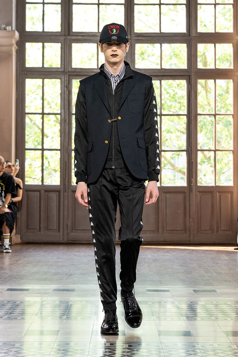 JUNYA WATANABE MAN SS27 Blends Streetwear Icons and Luxury Tailoring Under "BLING BLING BLING" Theme paris fashion week spring summer 2027 runway Kappa  Needles  Carhartt  Levi’s  Luigi Borrelli  Guy Rover  Maria Santangelo  INNERRAUM  47  HIDDEN   Union LA  DHL  Flake  New Balance  Heinrich Dinkelacker  Tricker's 
