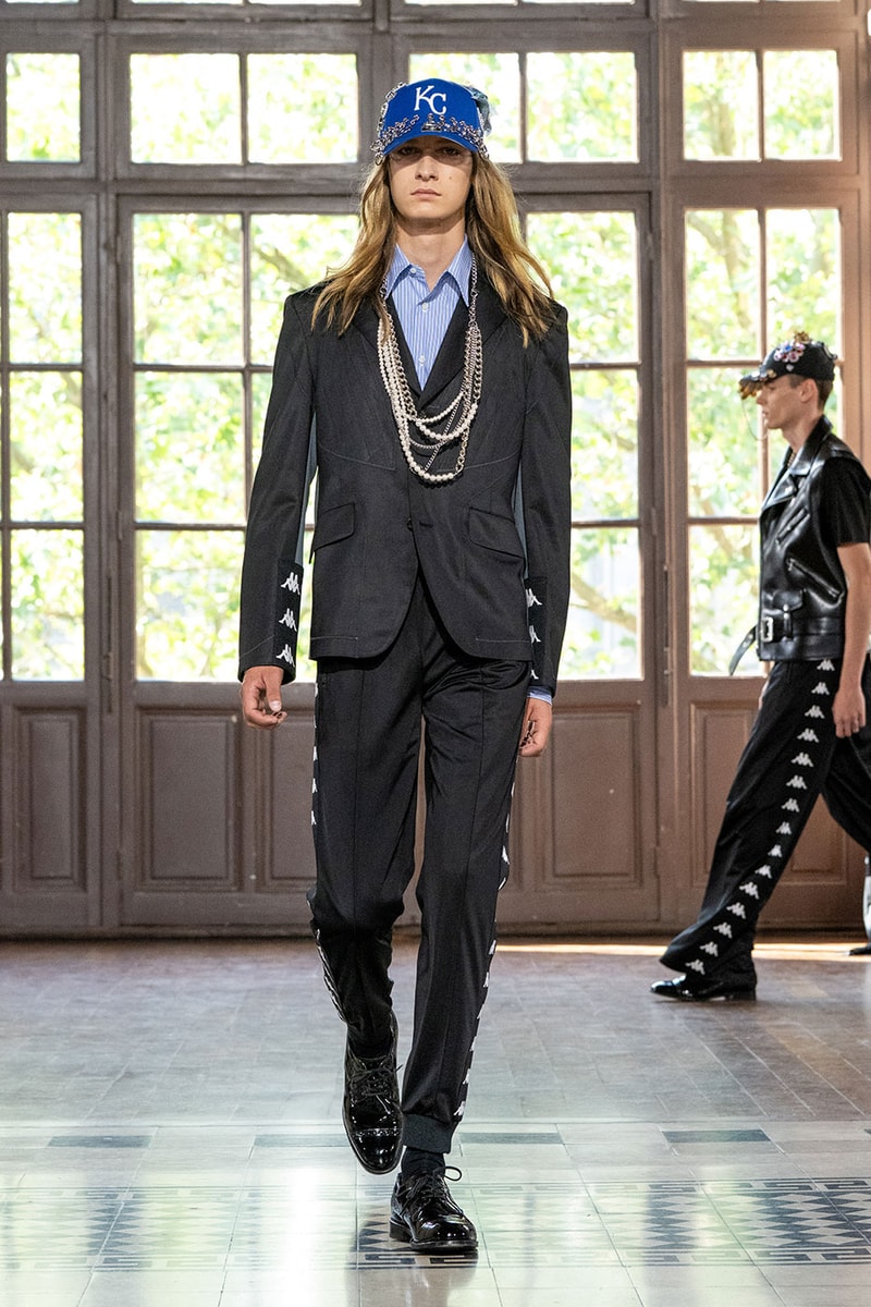 JUNYA WATANABE MAN SS27 Blends Streetwear Icons and Luxury Tailoring Under "BLING BLING BLING" Theme paris fashion week spring summer 2027 runway Kappa  Needles  Carhartt  Levi’s  Luigi Borrelli  Guy Rover  Maria Santangelo  INNERRAUM  47  HIDDEN   Union LA  DHL  Flake  New Balance  Heinrich Dinkelacker  Tricker's 
