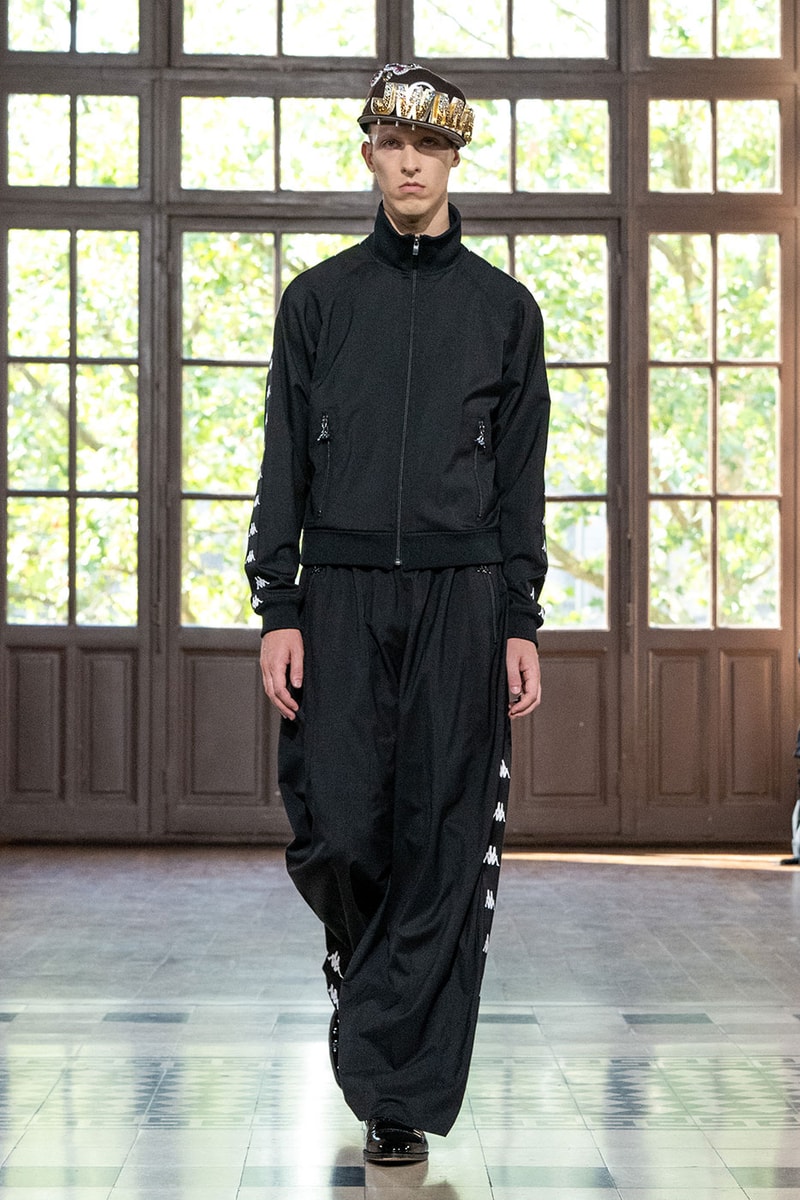 JUNYA WATANABE MAN SS27 Blends Streetwear Icons and Luxury Tailoring Under "BLING BLING BLING" Theme paris fashion week spring summer 2027 runway Kappa  Needles  Carhartt  Levi’s  Luigi Borrelli  Guy Rover  Maria Santangelo  INNERRAUM  47  HIDDEN   Union LA  DHL  Flake  New Balance  Heinrich Dinkelacker  Tricker's 