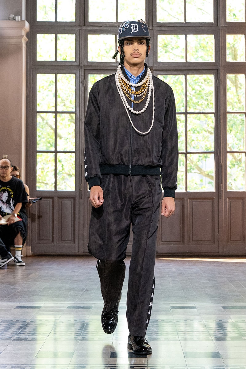 JUNYA WATANABE MAN SS27 Blends Streetwear Icons and Luxury Tailoring Under "BLING BLING BLING" Theme paris fashion week spring summer 2027 runway Kappa  Needles  Carhartt  Levi’s  Luigi Borrelli  Guy Rover  Maria Santangelo  INNERRAUM  47  HIDDEN   Union LA  DHL  Flake  New Balance  Heinrich Dinkelacker  Tricker's 