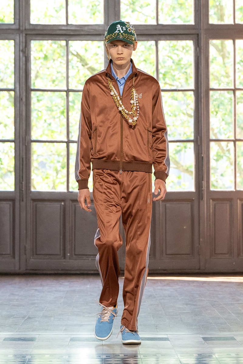 JUNYA WATANABE MAN SS27 Blends Streetwear Icons and Luxury Tailoring Under "BLING BLING BLING" Theme paris fashion week spring summer 2027 runway Kappa  Needles  Carhartt  Levi’s  Luigi Borrelli  Guy Rover  Maria Santangelo  INNERRAUM  47  HIDDEN   Union LA  DHL  Flake  New Balance  Heinrich Dinkelacker  Tricker's 