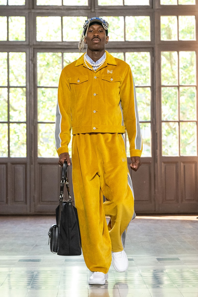 JUNYA WATANABE MAN SS27 Blends Streetwear Icons and Luxury Tailoring Under "BLING BLING BLING" Theme paris fashion week spring summer 2027 runway Kappa  Needles  Carhartt  Levi’s  Luigi Borrelli  Guy Rover  Maria Santangelo  INNERRAUM  47  HIDDEN   Union LA  DHL  Flake  New Balance  Heinrich Dinkelacker  Tricker's 