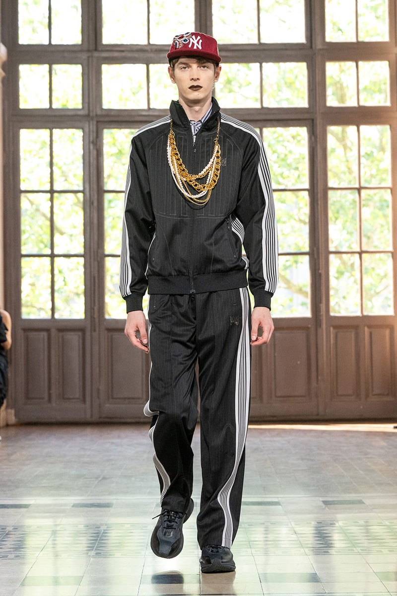 JUNYA WATANABE MAN SS27 Blends Streetwear Icons and Luxury Tailoring Under "BLING BLING BLING" Theme paris fashion week spring summer 2027 runway Kappa  Needles  Carhartt  Levi’s  Luigi Borrelli  Guy Rover  Maria Santangelo  INNERRAUM  47  HIDDEN   Union LA  DHL  Flake  New Balance  Heinrich Dinkelacker  Tricker's 