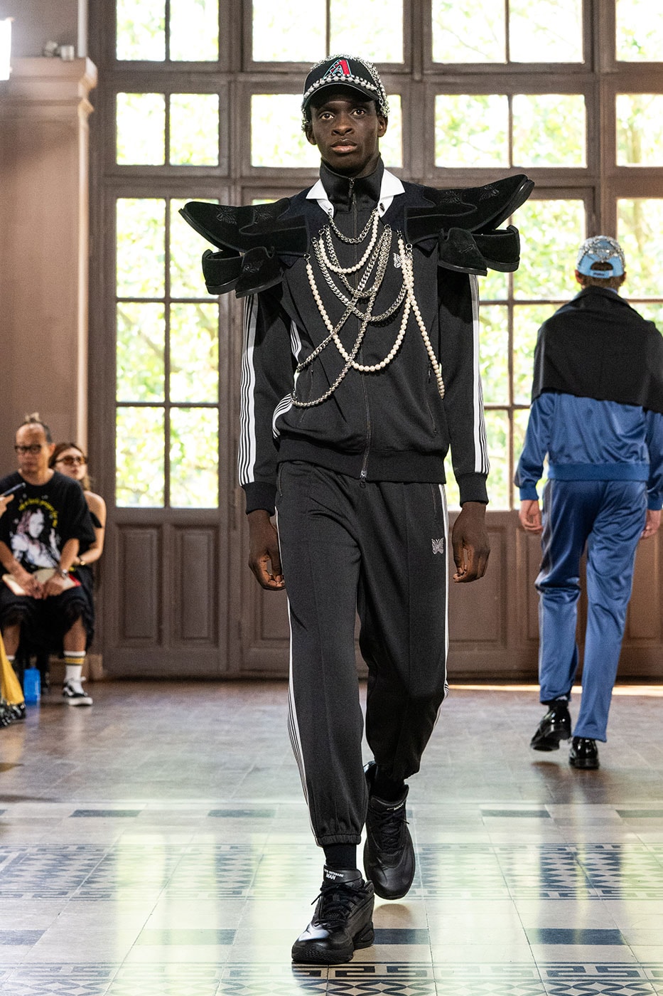 JUNYA WATANABE MAN SS27 Blends Streetwear Icons and Luxury Tailoring Under "BLING BLING BLING" Theme paris fashion week spring summer 2027 runway Kappa  Needles  Carhartt  Levi’s  Luigi Borrelli  Guy Rover  Maria Santangelo  INNERRAUM  47  HIDDEN   Union LA  DHL  Flake  New Balance  Heinrich Dinkelacker  Tricker's 