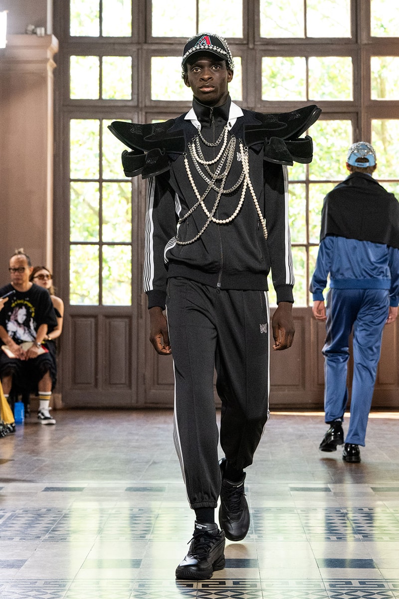 JUNYA WATANABE MAN SS27 Blends Streetwear Icons and Luxury Tailoring Under "BLING BLING BLING" Theme paris fashion week spring summer 2027 runway Kappa  Needles  Carhartt  Levi’s  Luigi Borrelli  Guy Rover  Maria Santangelo  INNERRAUM  47  HIDDEN   Union LA  DHL  Flake  New Balance  Heinrich Dinkelacker  Tricker's 
