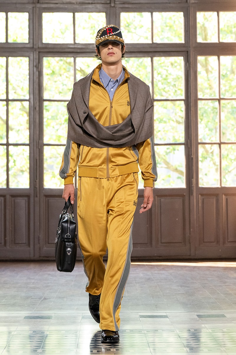 JUNYA WATANABE MAN SS27 Blends Streetwear Icons and Luxury Tailoring Under "BLING BLING BLING" Theme paris fashion week spring summer 2027 runway Kappa  Needles  Carhartt  Levi’s  Luigi Borrelli  Guy Rover  Maria Santangelo  INNERRAUM  47  HIDDEN   Union LA  DHL  Flake  New Balance  Heinrich Dinkelacker  Tricker's 