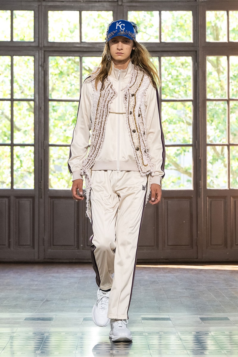 JUNYA WATANABE MAN SS27 Blends Streetwear Icons and Luxury Tailoring Under "BLING BLING BLING" Theme paris fashion week spring summer 2027 runway Kappa  Needles  Carhartt  Levi’s  Luigi Borrelli  Guy Rover  Maria Santangelo  INNERRAUM  47  HIDDEN   Union LA  DHL  Flake  New Balance  Heinrich Dinkelacker  Tricker's 