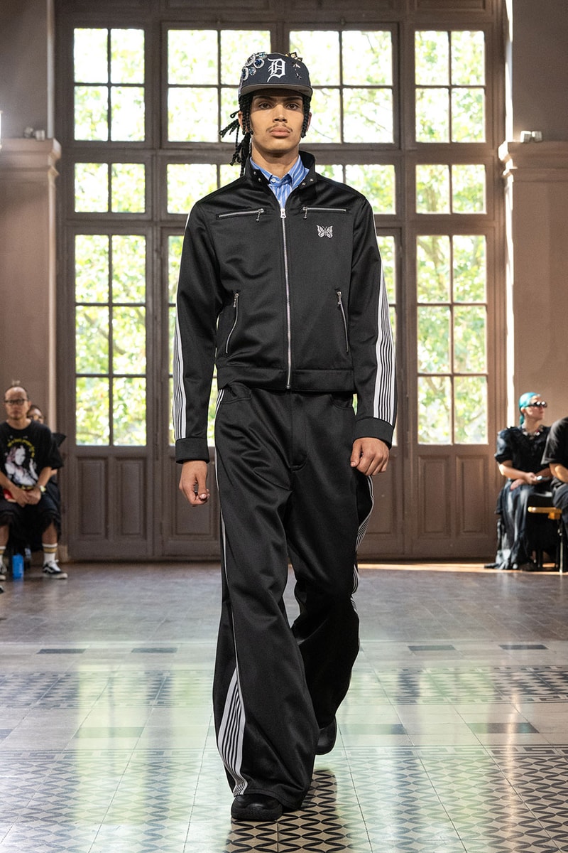 JUNYA WATANABE MAN SS27 Blends Streetwear Icons and Luxury Tailoring Under "BLING BLING BLING" Theme paris fashion week spring summer 2027 runway Kappa  Needles  Carhartt  Levi’s  Luigi Borrelli  Guy Rover  Maria Santangelo  INNERRAUM  47  HIDDEN   Union LA  DHL  Flake  New Balance  Heinrich Dinkelacker  Tricker's 