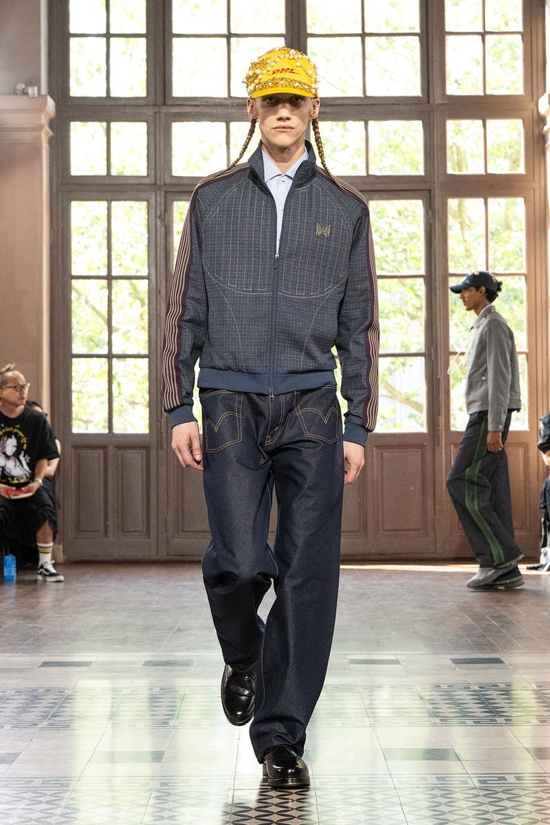 JUNYA WATANABE MAN SS27 Blends Streetwear Icons and Luxury Tailoring Under "BLING BLING BLING" Theme paris fashion week spring summer 2027 runway Kappa  Needles  Carhartt  Levi’s  Luigi Borrelli  Guy Rover  Maria Santangelo  INNERRAUM  47  HIDDEN   Union LA  DHL  Flake  New Balance  Heinrich Dinkelacker  Tricker's 