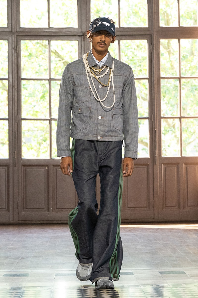 JUNYA WATANABE MAN SS27 Blends Streetwear Icons and Luxury Tailoring Under "BLING BLING BLING" Theme paris fashion week spring summer 2027 runway Kappa  Needles  Carhartt  Levi’s  Luigi Borrelli  Guy Rover  Maria Santangelo  INNERRAUM  47  HIDDEN   Union LA  DHL  Flake  New Balance  Heinrich Dinkelacker  Tricker's 