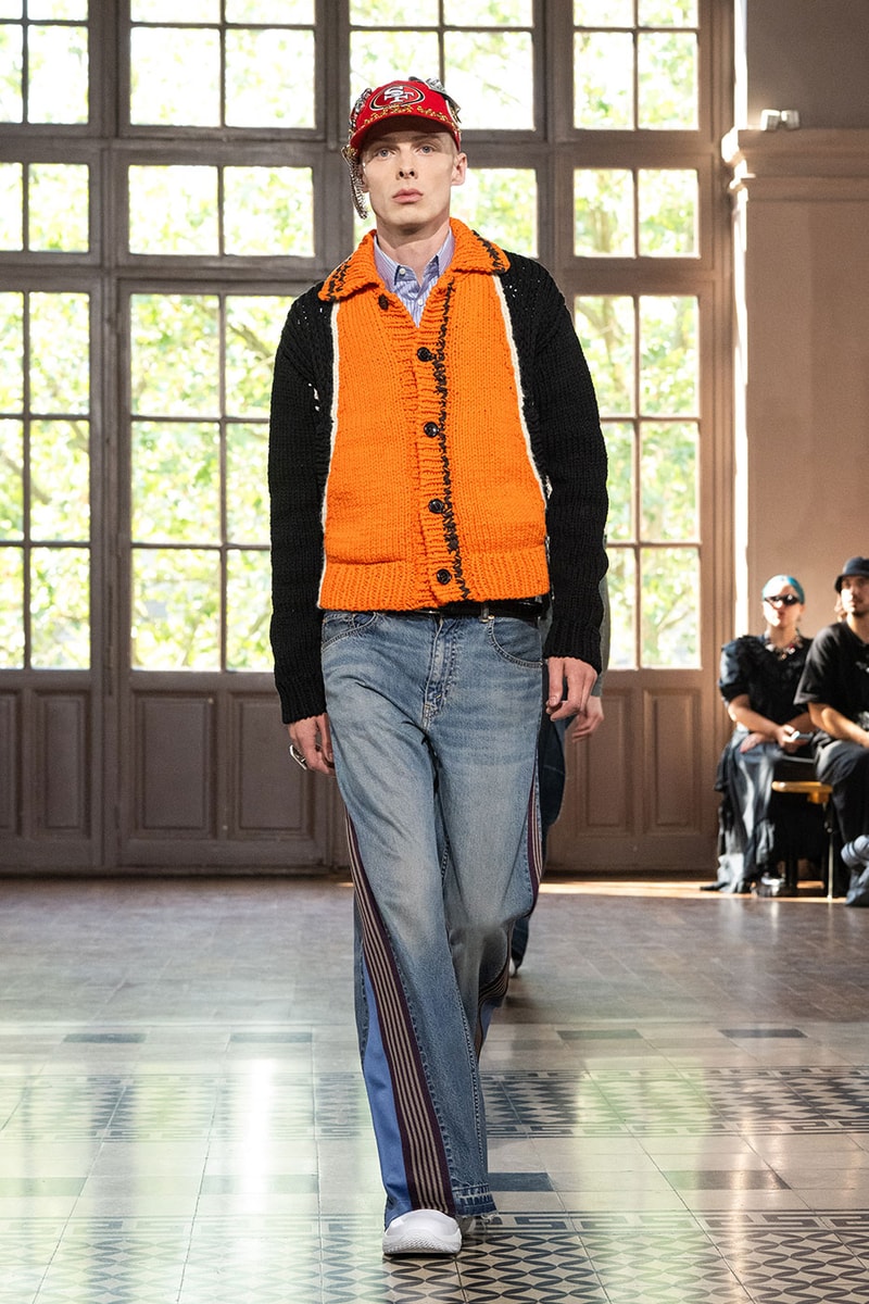 JUNYA WATANABE MAN SS27 Blends Streetwear Icons and Luxury Tailoring Under "BLING BLING BLING" Theme paris fashion week spring summer 2027 runway Kappa  Needles  Carhartt  Levi’s  Luigi Borrelli  Guy Rover  Maria Santangelo  INNERRAUM  47  HIDDEN   Union LA  DHL  Flake  New Balance  Heinrich Dinkelacker  Tricker's 