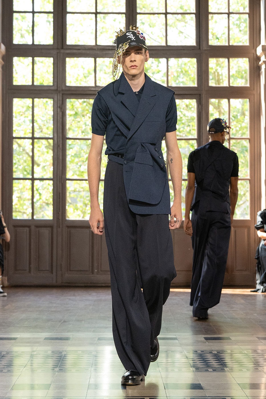 JUNYA WATANABE MAN SS27 Blends Streetwear Icons and Luxury Tailoring Under "BLING BLING BLING" Theme paris fashion week spring summer 2027 runway Kappa  Needles  Carhartt  Levi’s  Luigi Borrelli  Guy Rover  Maria Santangelo  INNERRAUM  47  HIDDEN   Union LA  DHL  Flake  New Balance  Heinrich Dinkelacker  Tricker's 