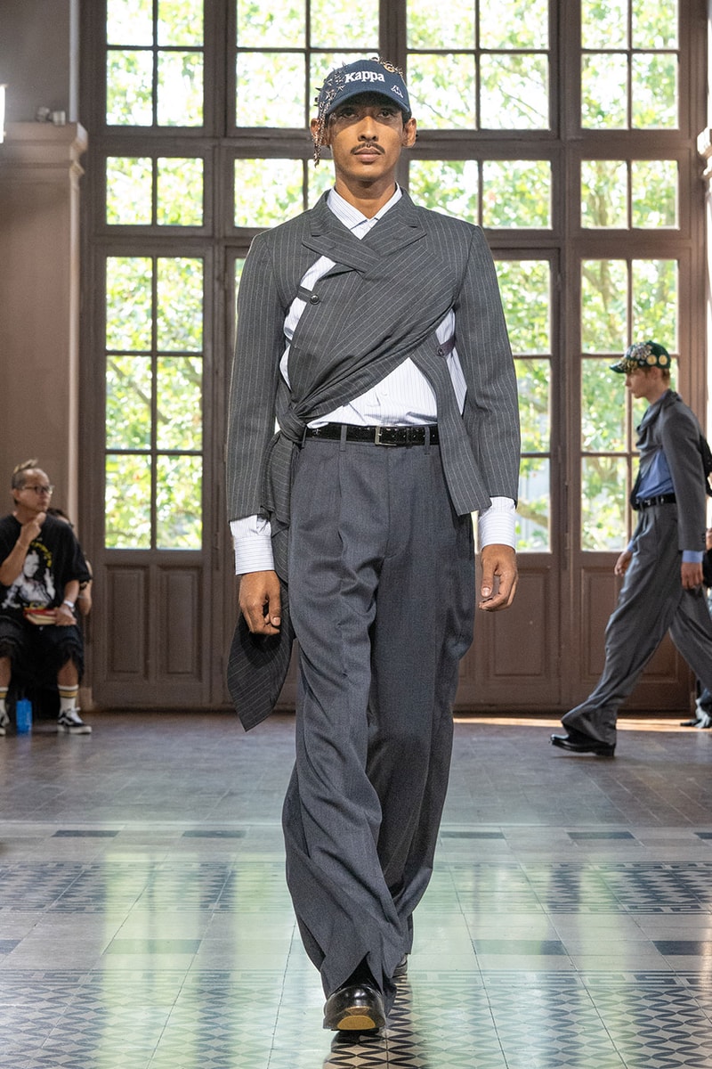 JUNYA WATANABE MAN SS27 Blends Streetwear Icons and Luxury Tailoring Under "BLING BLING BLING" Theme paris fashion week spring summer 2027 runway Kappa  Needles  Carhartt  Levi’s  Luigi Borrelli  Guy Rover  Maria Santangelo  INNERRAUM  47  HIDDEN   Union LA  DHL  Flake  New Balance  Heinrich Dinkelacker  Tricker's 