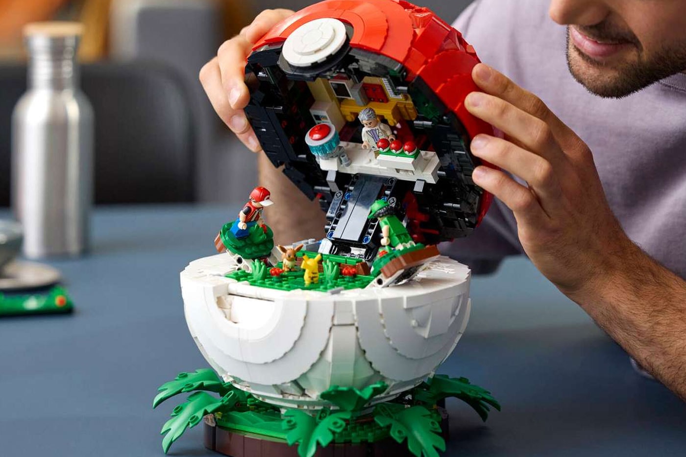 LEGO's "Iconic Trainer Moments" Poké Ball Is a Masterclass in Hidden Brick Construction first-ever human Pokémon minifigures collaboration pokemon professor oak famous laboratory