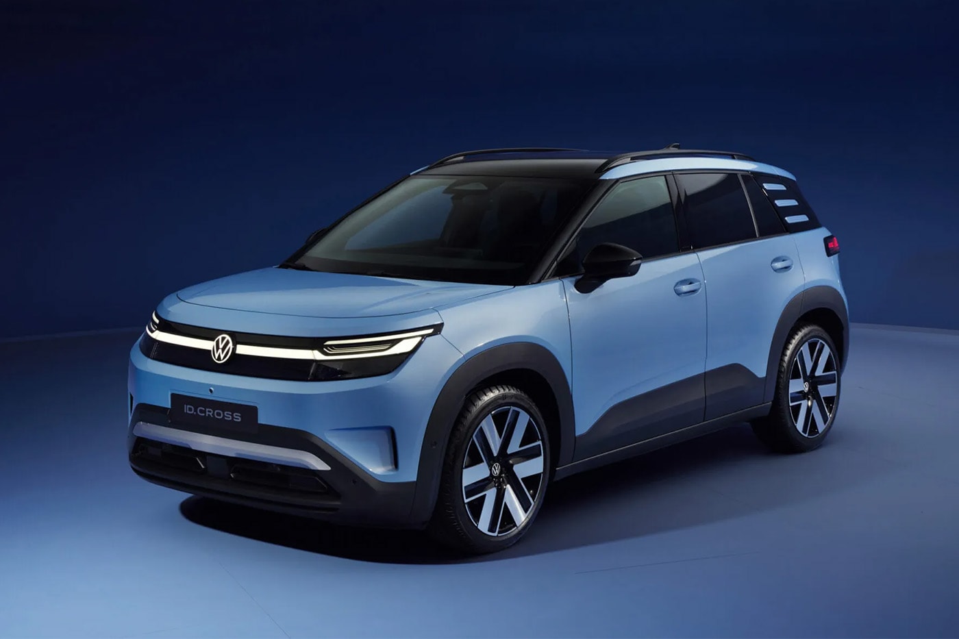 Volkswagen ID. Cross electric SUV on road showcasing compact proportions and clean LED lighting