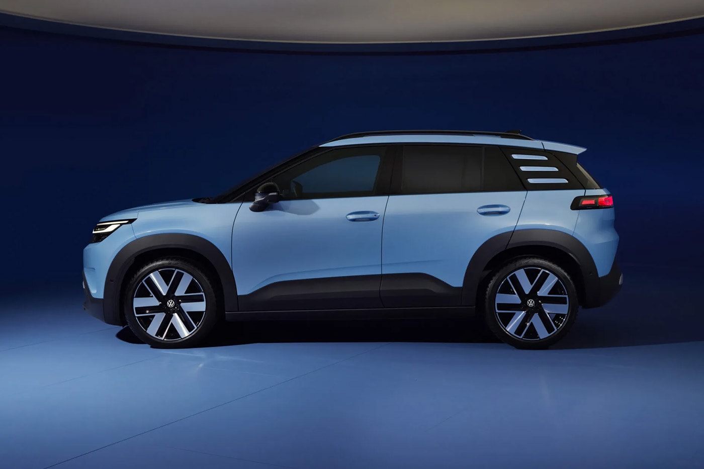 Volkswagen ID. Cross electric SUV on road showcasing compact proportions and clean LED lighting