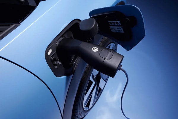 Volkswagen ID. Cross electric SUV on road showcasing compact proportions and clean LED lighting