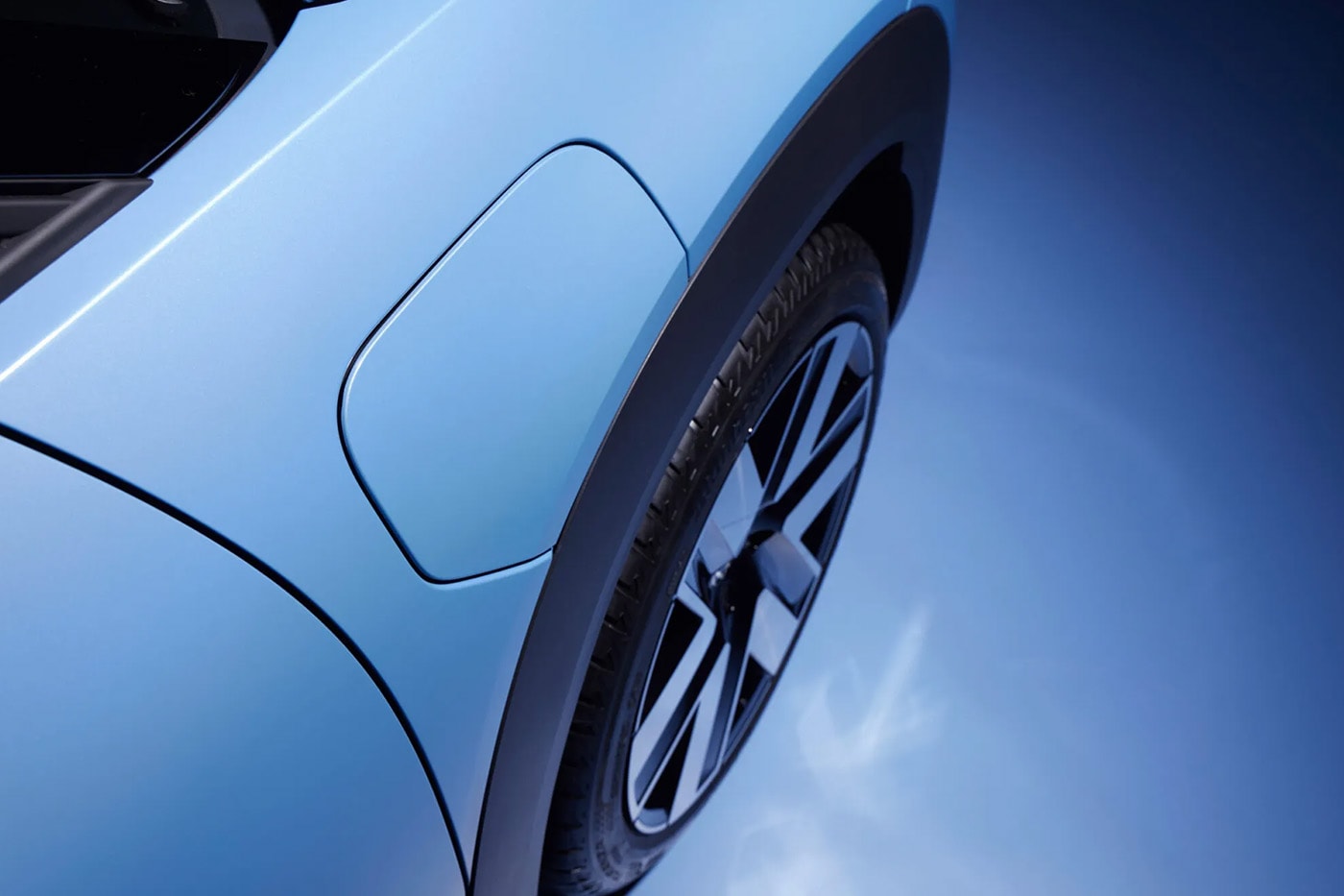 Volkswagen ID. Cross electric SUV on road showcasing compact proportions and clean LED lighting