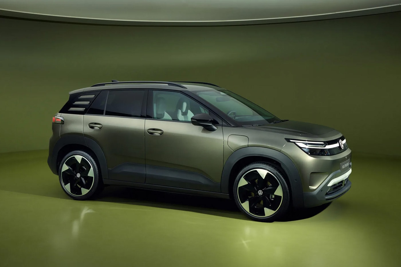 Volkswagen ID. Cross electric SUV on road showcasing compact proportions and clean LED lighting