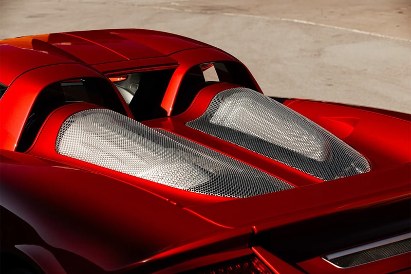 Porsche Carrera GT in Ferrari Rosso Fuoco at Mecum Monterey auction lot display