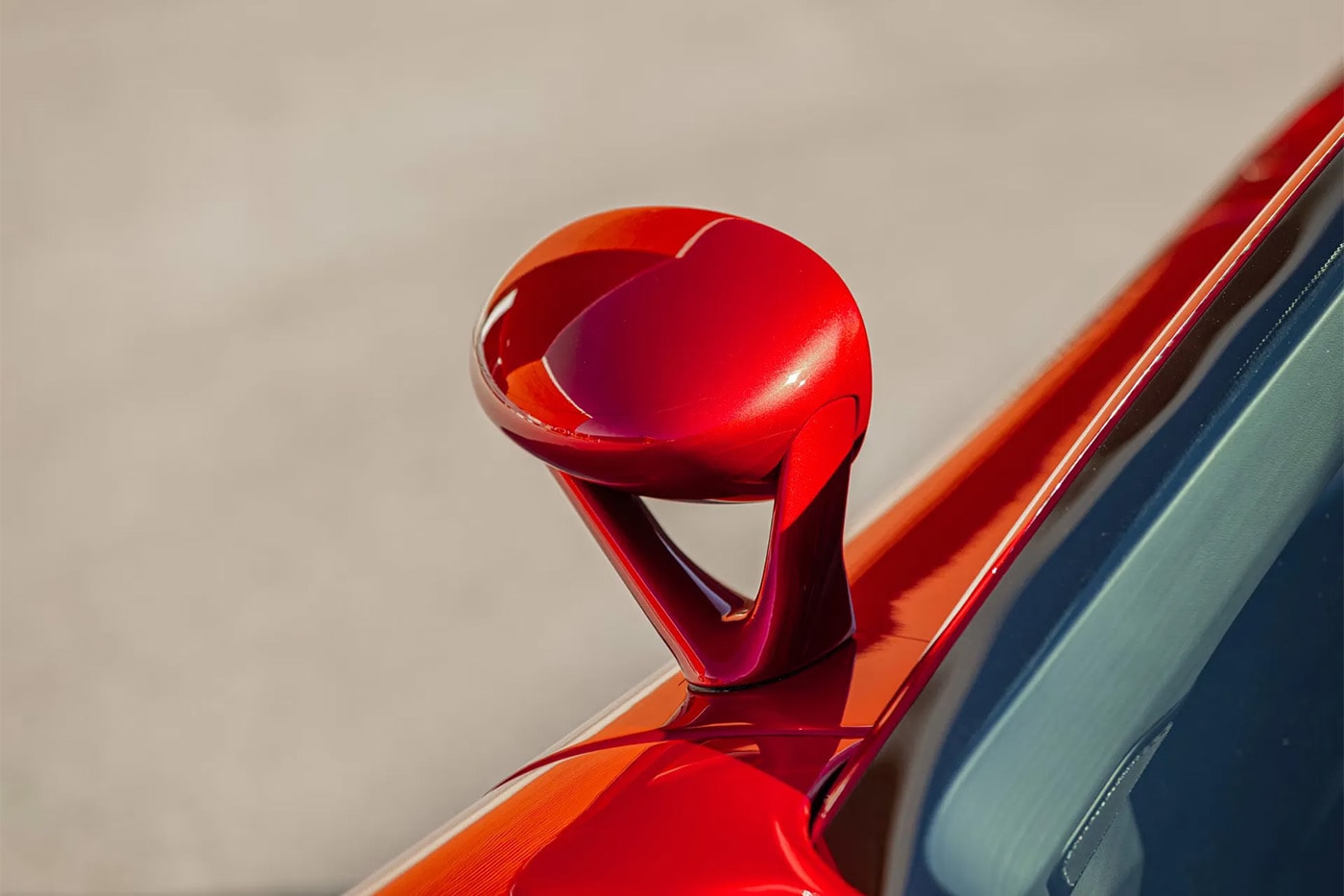 Porsche Carrera GT in Ferrari Rosso Fuoco at Mecum Monterey auction lot display