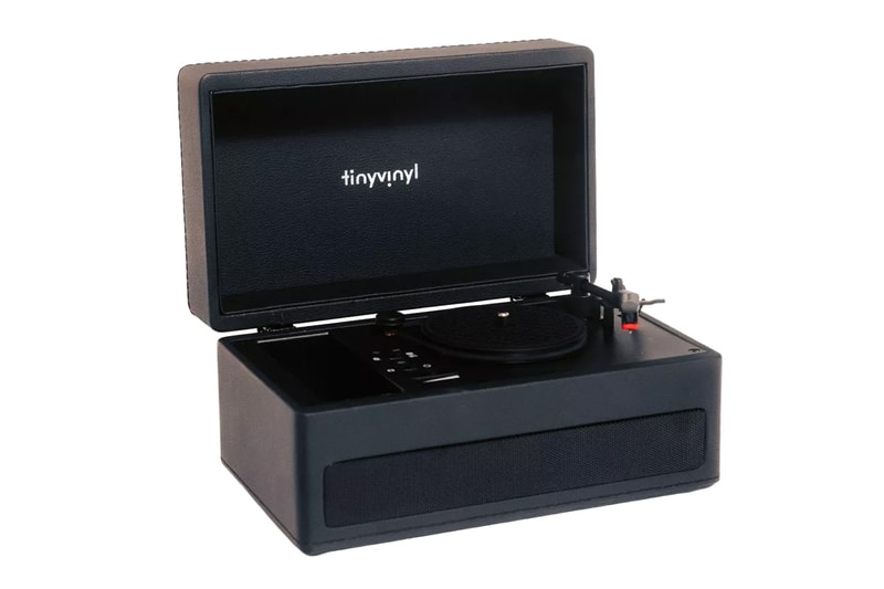 Tiny Vinyl player turntable spinning four-inch records with black leatherette suitcase design