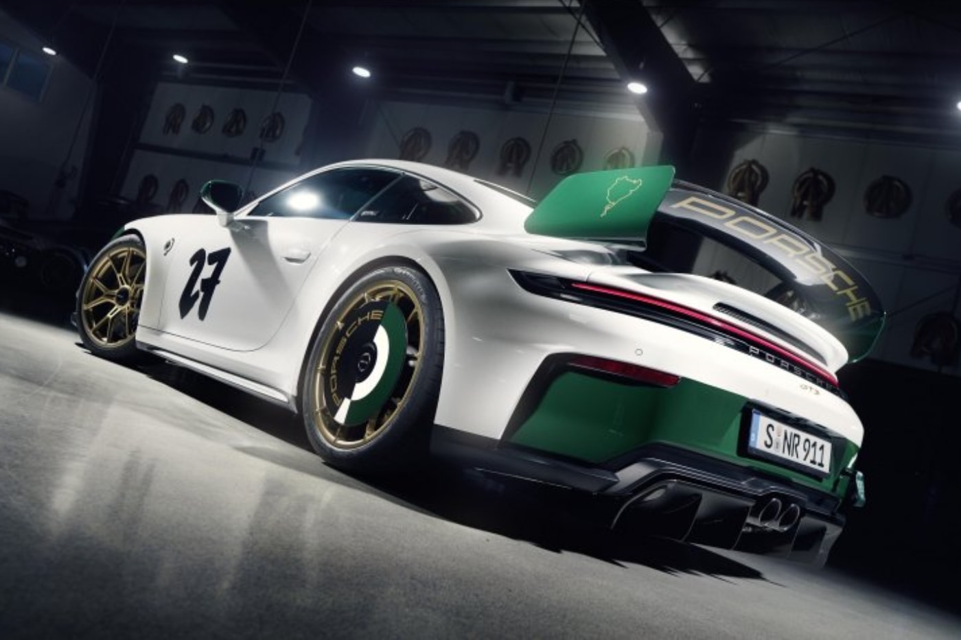Porsche 911 GT3 100 Jahre Nürburgring in Green Hell livery with gold center-lock wheels on track