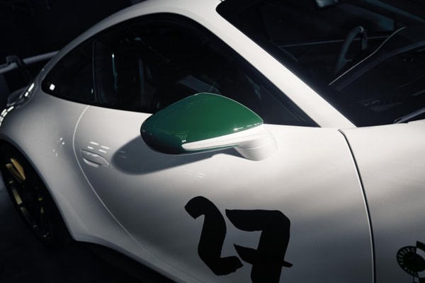 Porsche 911 GT3 100 Jahre Nürburgring in Green Hell livery with gold center-lock wheels on track