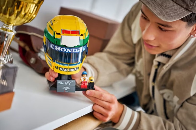 LEGO Editions Ayrton Senna Helmet 43024 with yellow Brazilian livery on display stand with minifigure