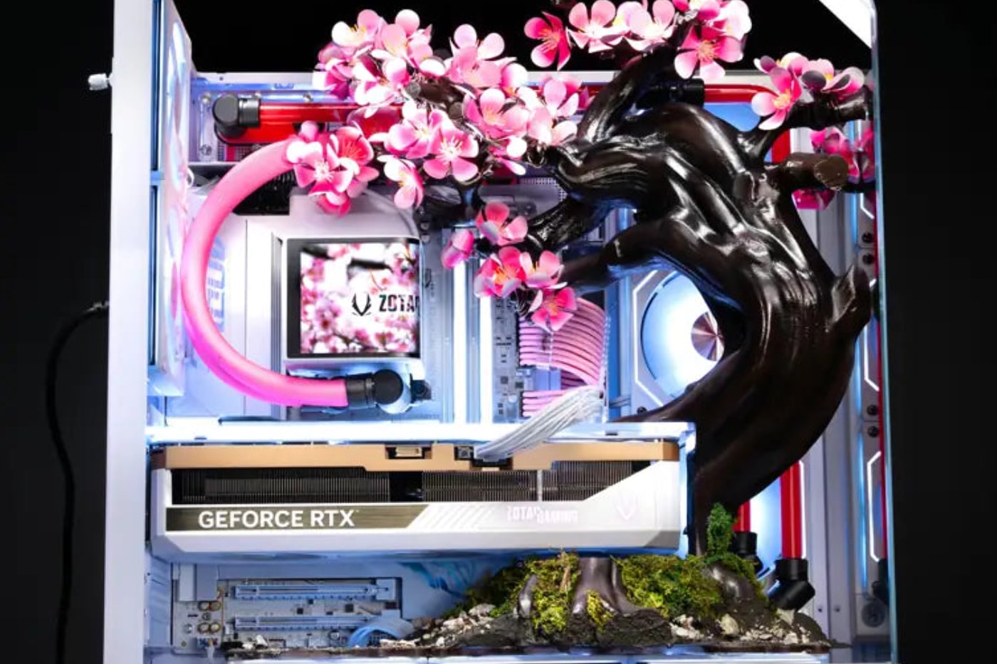 AFTERSHOCK Cherry Bloom gaming PC featuring kinetic titanium blossoms in an APNX V2 chassis.